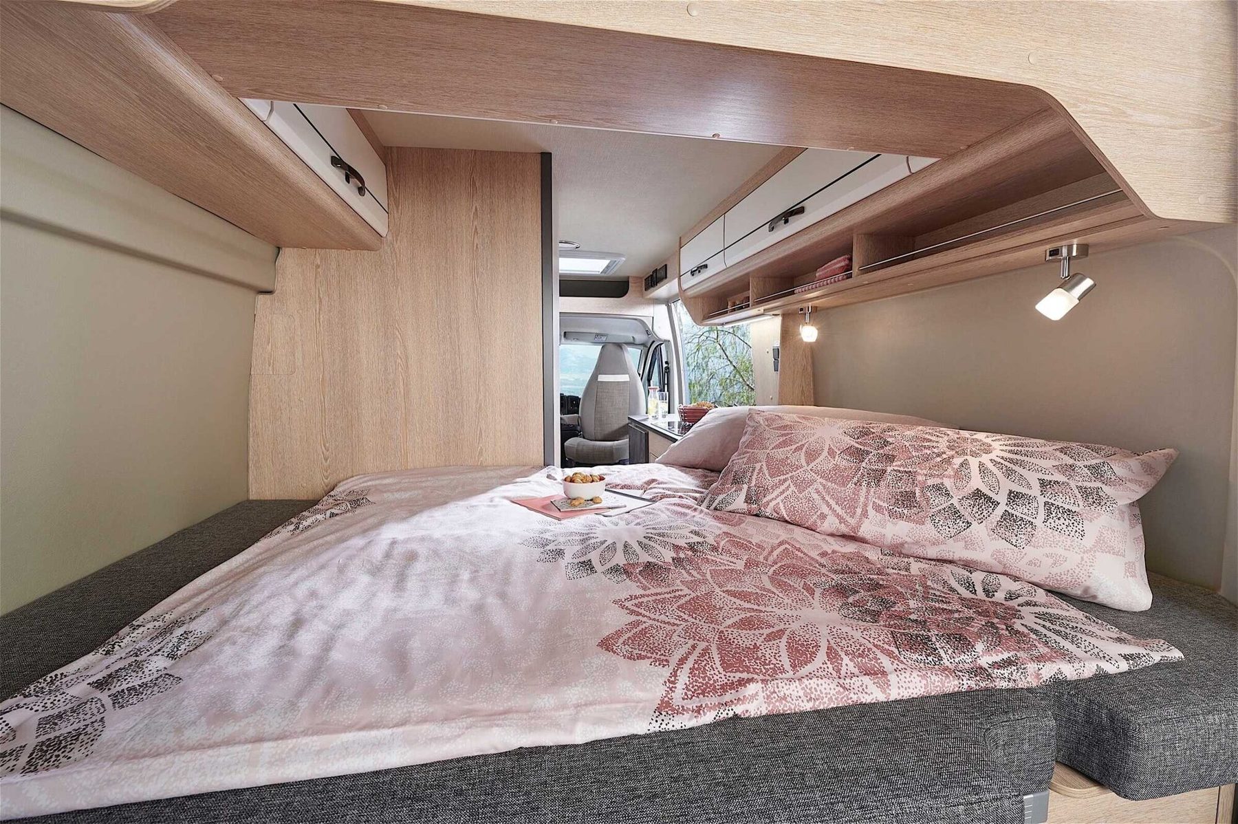 Gemütliches Längs-Doppelbett im Heck mit Panoramafenster für erholsame Nächte
